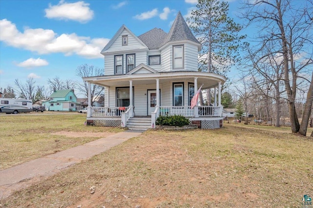 victorian house featuring a front lawn and a porch