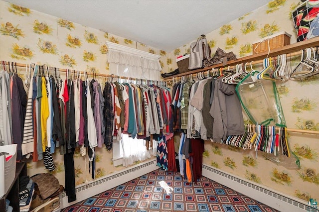 spacious closet with baseboard heating