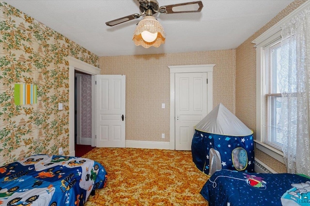 bedroom with a textured ceiling and ceiling fan