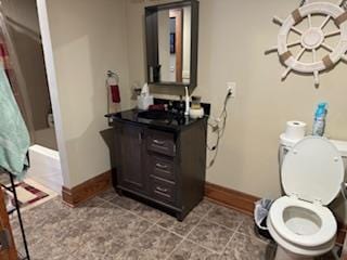 bathroom featuring oversized vanity, toilet, and tile flooring