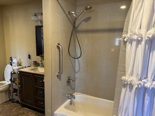 full bathroom with shower / tub combo with curtain, vanity, and toilet