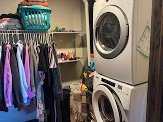 laundry area featuring stacked washer / drying machine