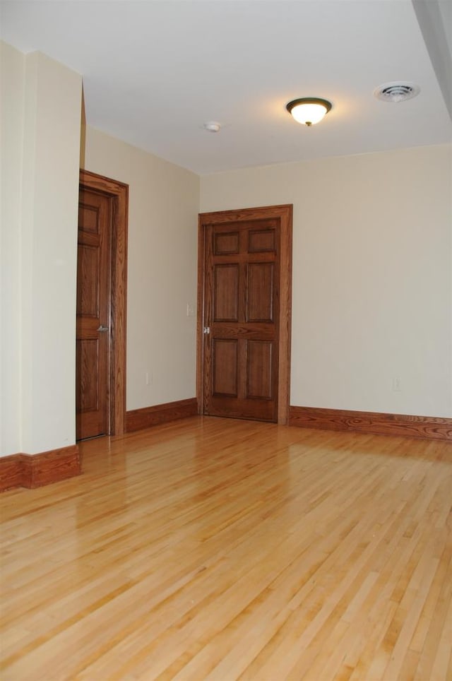 unfurnished room with light hardwood / wood-style floors