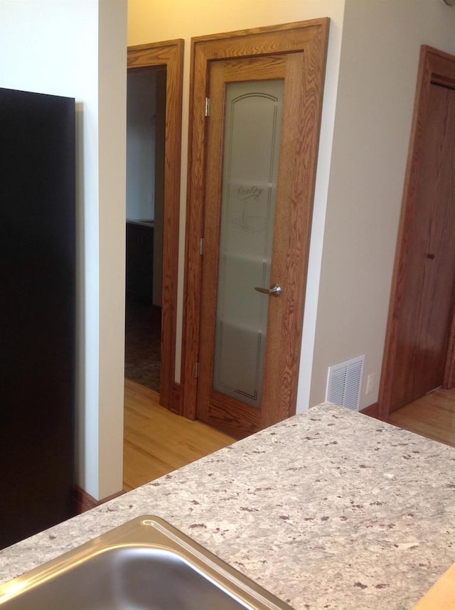 interior space featuring sink and light hardwood / wood-style floors