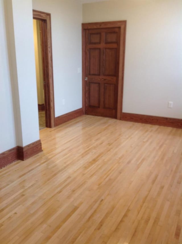 spare room with light wood-type flooring