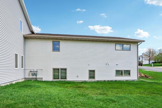 rear view of property with a yard