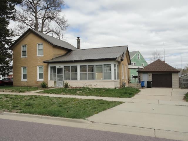 view of front of property with an outdoor structure and a garage