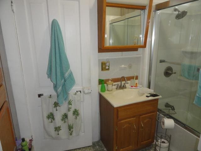 bathroom featuring vanity and combined bath / shower with glass door