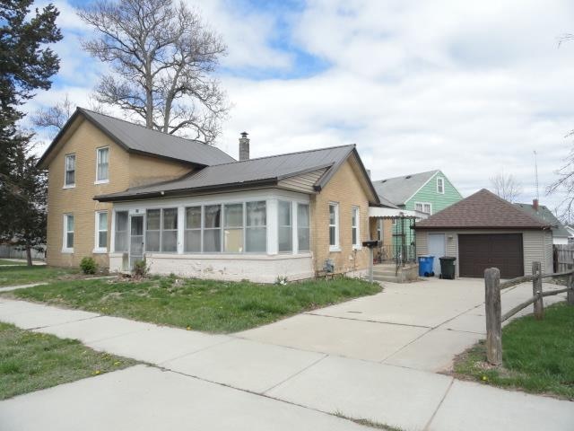 view of front of property featuring a garage and an outdoor structure