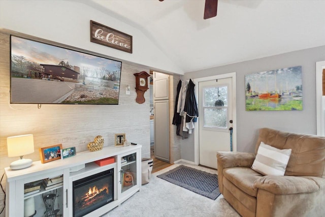 sitting room with lofted ceiling, ceiling fan, and light carpet