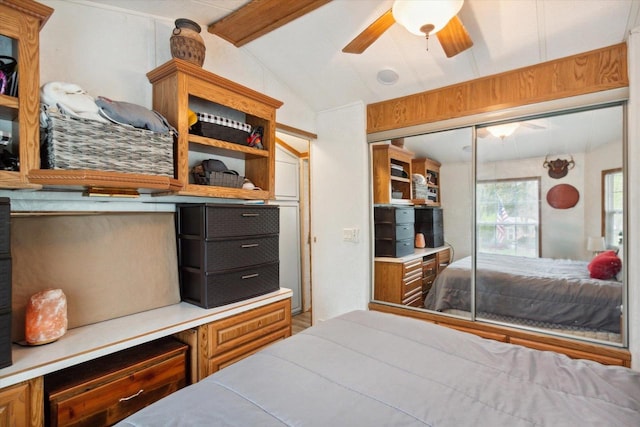 bedroom with lofted ceiling with beams, a closet, and ceiling fan