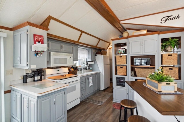 kitchen with vaulted ceiling with beams, white appliances, gray cabinets, and dark wood-type flooring