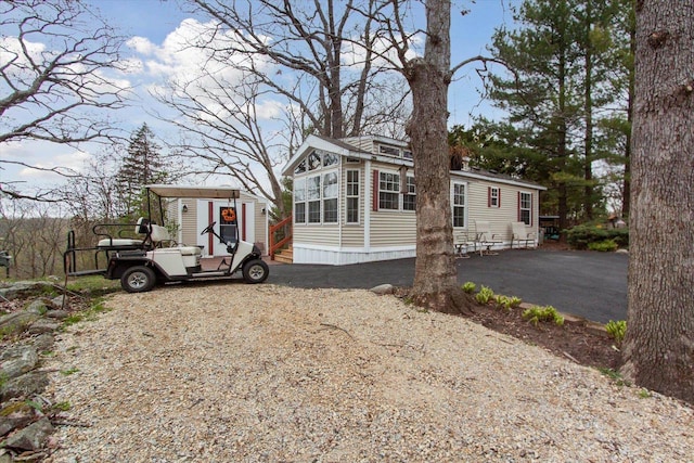 view of front of property featuring a carport