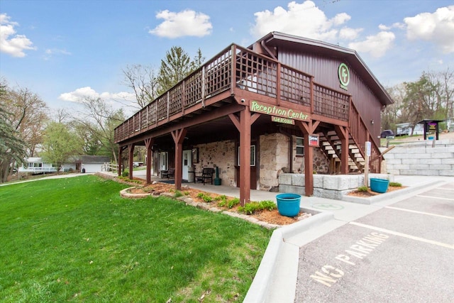 view of home's community with a patio, a deck, and a lawn