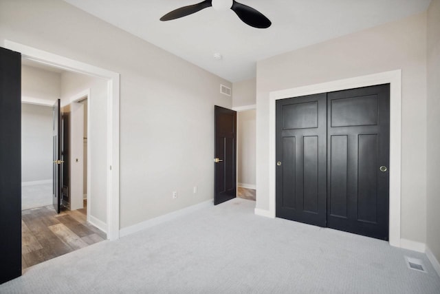 bedroom featuring hardwood / wood-style flooring, a closet, and ceiling fan