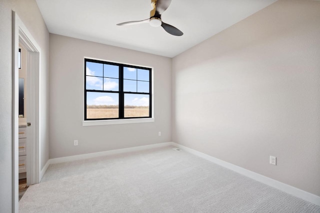 spare room featuring ceiling fan and carpet