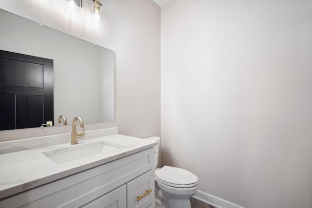 bathroom with toilet and vanity