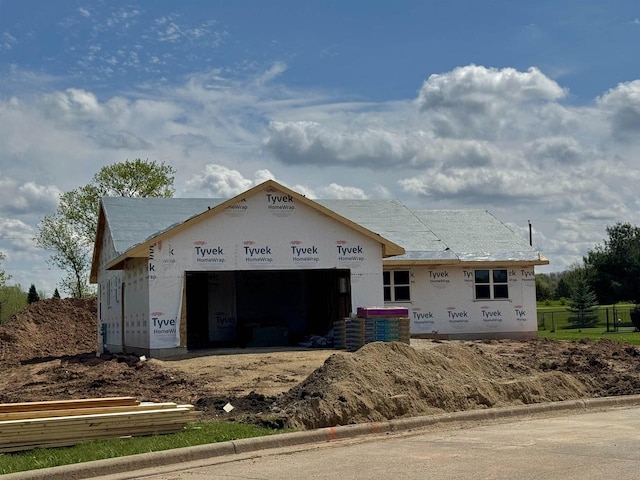 unfinished property featuring a garage