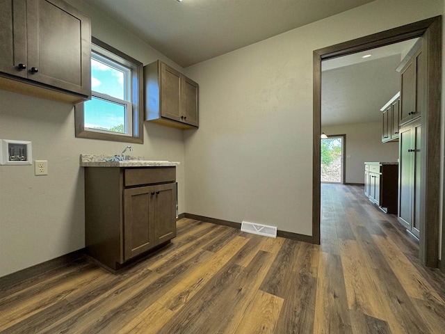 interior space featuring sink, dark hardwood / wood-style floors, and a healthy amount of sunlight