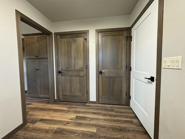 corridor with dark wood-type flooring