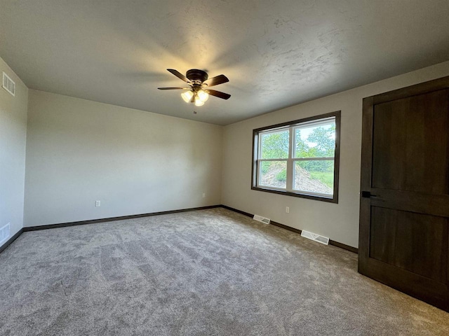 unfurnished bedroom with carpet flooring, a textured ceiling, and ceiling fan