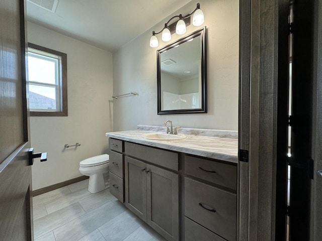 bathroom featuring vanity and toilet