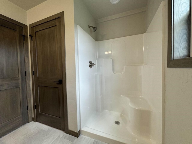 bathroom with wood-type flooring and a shower