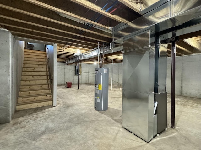 basement with electric water heater, heating unit, and electric panel