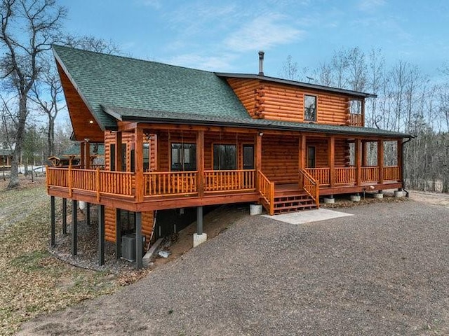 rear view of property with covered porch