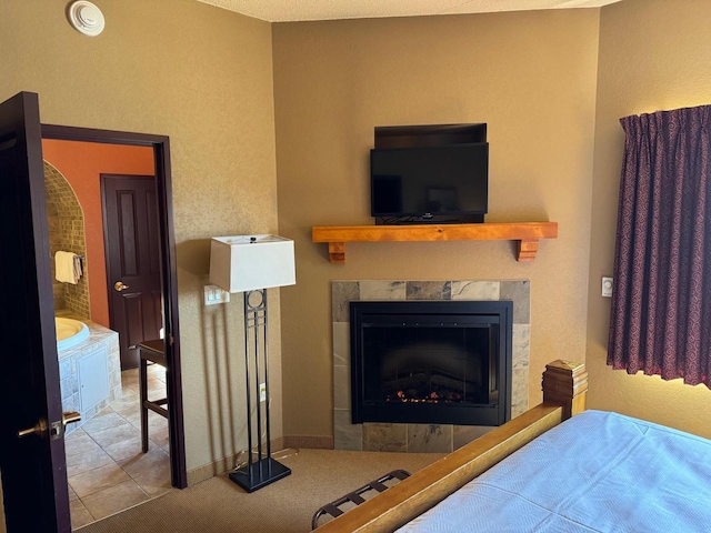 tiled bedroom featuring a tiled fireplace