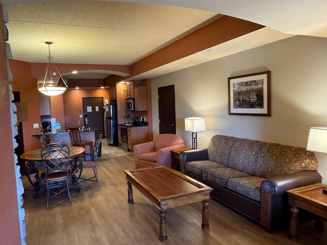 living room featuring a textured ceiling and hardwood / wood-style floors