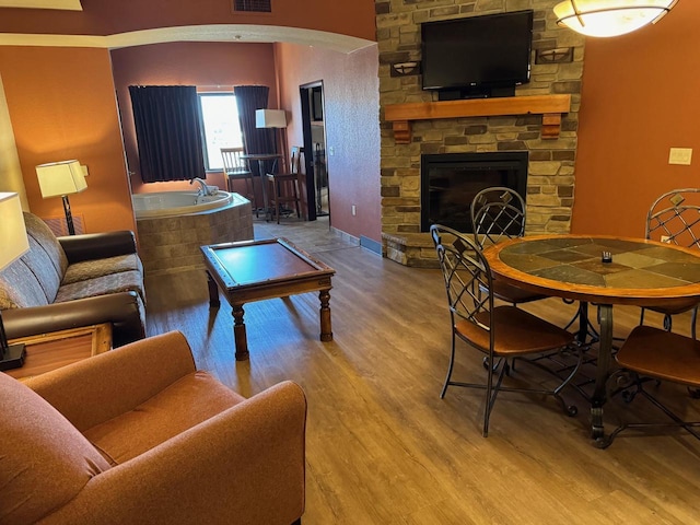 living room featuring wood-type flooring and a fireplace