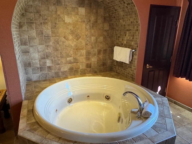 room details with a tub, a jacuzzi, and tile flooring