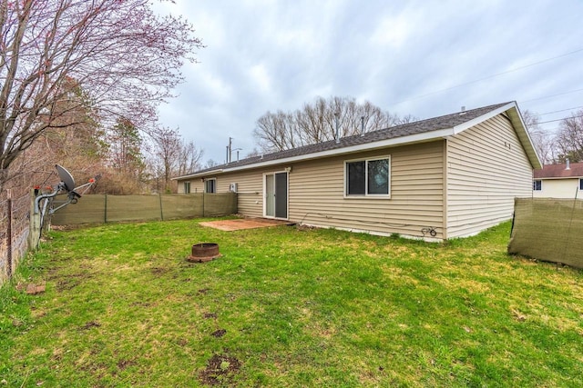 rear view of property with a lawn