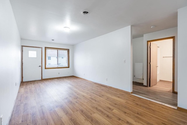 unfurnished room with hardwood / wood-style flooring