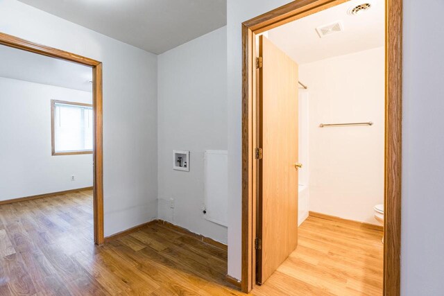 hallway with light hardwood / wood-style flooring