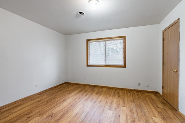 empty room with light hardwood / wood-style floors