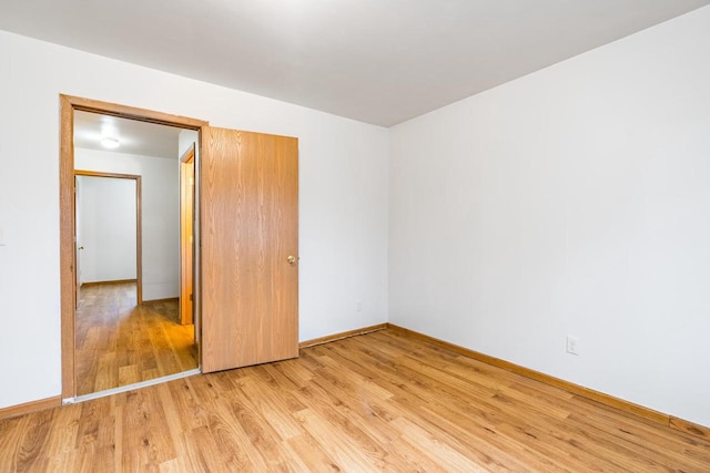 unfurnished bedroom featuring a closet and light hardwood / wood-style floors