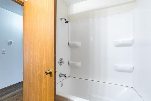 bathroom featuring shower / washtub combination and wood-type flooring