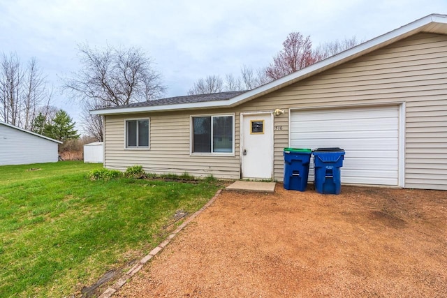 single story home with a garage and a front lawn