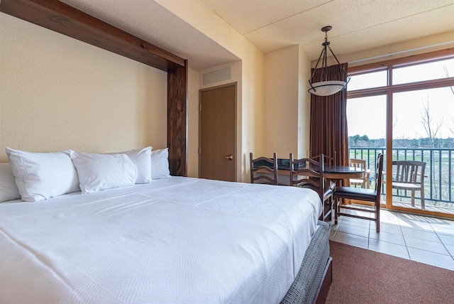 bedroom featuring tile flooring, access to exterior, and a textured ceiling