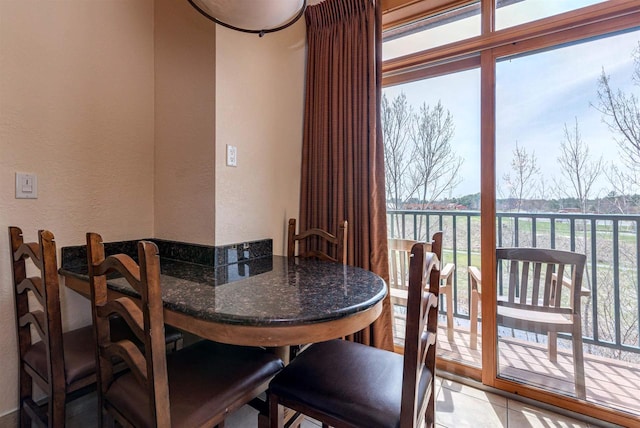 dining space featuring light tile floors and a wealth of natural light