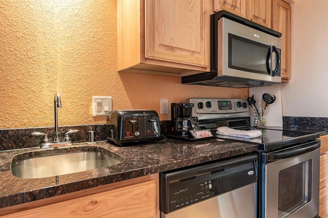 kitchen with sink, appliances with stainless steel finishes, and light brown cabinets