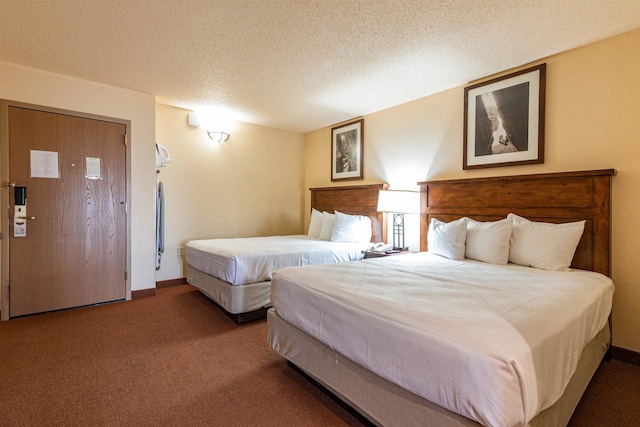 bedroom with a textured ceiling and carpet floors