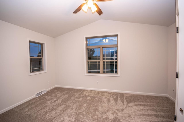 empty room with ceiling fan, carpet, and vaulted ceiling