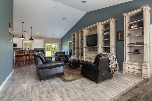 living room with hardwood / wood-style floors and lofted ceiling