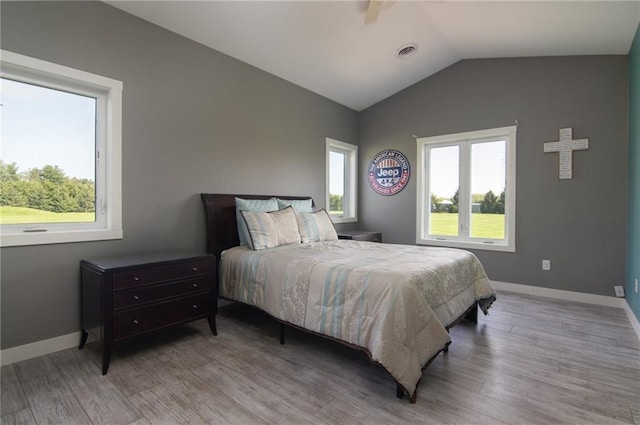 bedroom featuring hardwood / wood-style flooring and vaulted ceiling