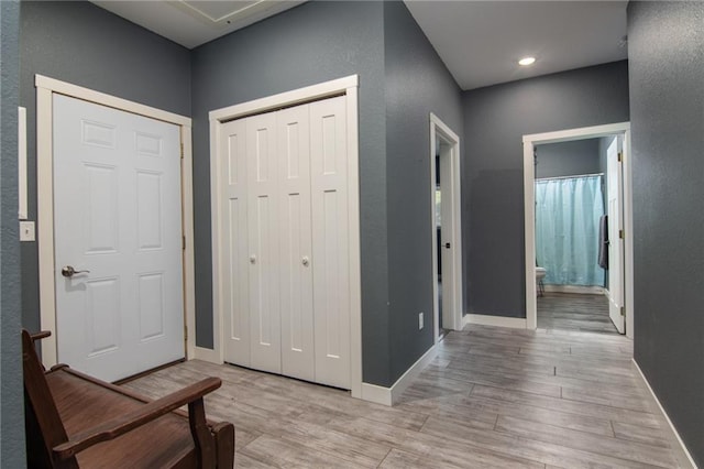 corridor with light hardwood / wood-style flooring