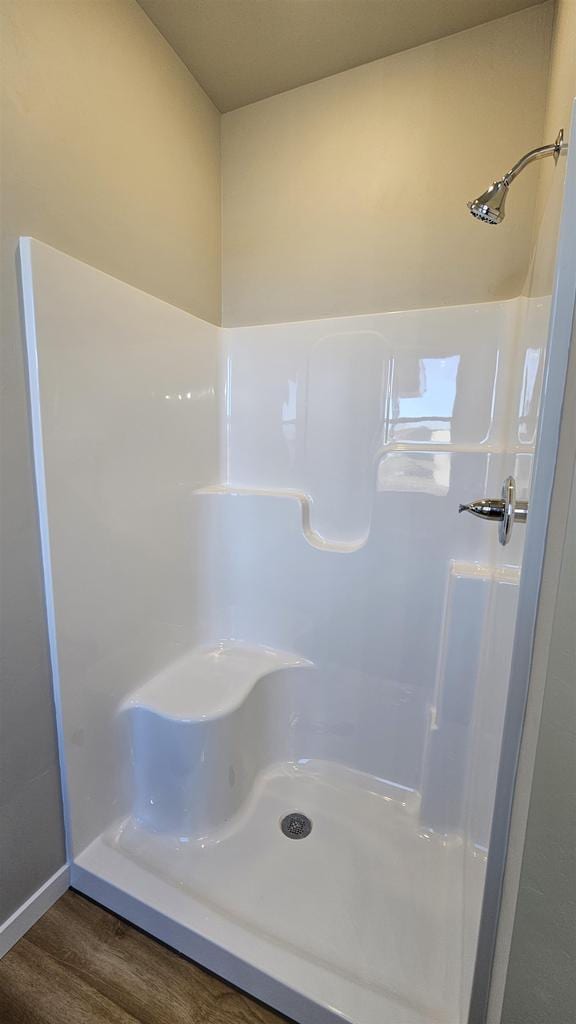 bathroom featuring hardwood / wood-style floors and walk in shower