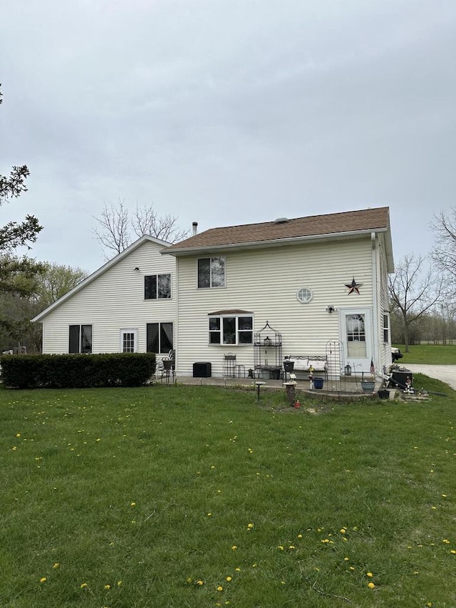 back of property with a patio and a lawn